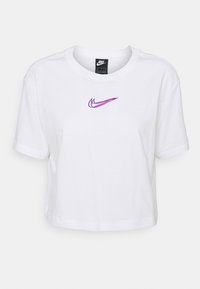 White cropped T-shirt made of cotton with short sleeves, featuring a purple Nike logo on the chest. Simple design with a crew neck.