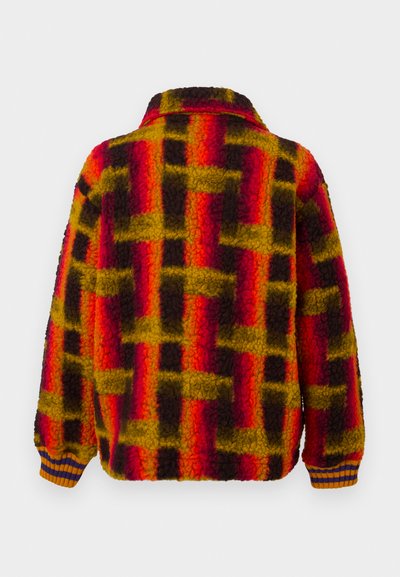 Veste en polaire avec un motif à carreaux coloré rouge, jaune et noir. Dotée d'un col et de poignets côtelés en orange et marine.
