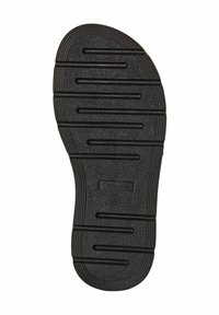 Zwarte rubberen schoenzool met een horizontaal ribbelpatroon en groeven voor grip, en een gestempeld label met de tekst "36" nabij de hiel.