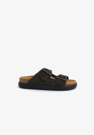 Black suede slide sandals with two adjustable straps, cork footbed, and a durable black rubber sole.