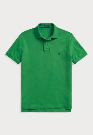 Green polo shirt made of cotton with a textured finish. Features a collar, three-button placket, and a small embroidered logo.