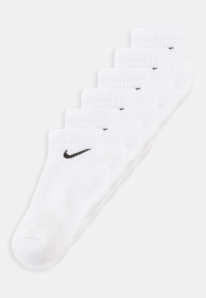 Valkeat puuvillaiset urheilusukat, joissa on ribattu resori, ja jokaisessa sukassa on musta Nike-viiru-logo. Kuusi paria esillä rivissä.
