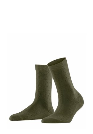Chaussettes vert olive foncé avec un bord côtes et un motif texturé à pois sur toute la surface. Fabriquées en matériau doux et extensible.