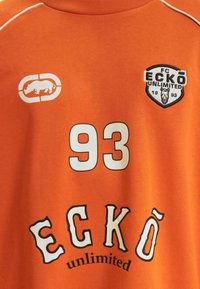 Orange cotton t-shirt featuring a white number "93" and "ECKŌ unlimited" in black and white lettering. Includes a logo with a rhinoceros.