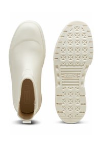 Bottines blanches en caoutchouc avec une surface texturée, dotées d'un design à enfiler, d'une semelle extérieure à motif et d'une petite languette au talon.