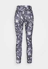Leggings avec une taille haute, en tissu extensible, présentant un motif géométrique noir et blanc avec des formes abstraites.