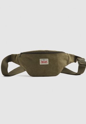 Olive green fabric waist bag with a front zipper and Levi Strauss & Co. logo patch, featuring an adjustable strap and plastic buckle.