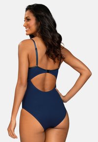Granatowy jednoczęściowy kostium kąpielowy z regulowanymi ramiączkami, odkrytymi plecami i gładką teksturą. Charakteryzuje się eleganckim wzornictwem i minimalistycznymi ozdobami.