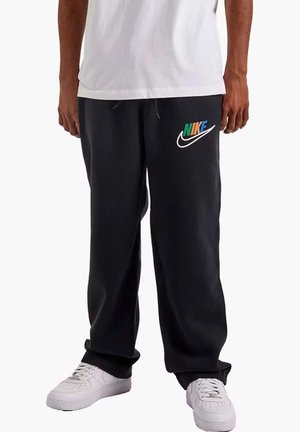 Nike joggingsbukser i sort med elastisk talje, sidelommer og et farverigt logo på venstre lår. Fremstillet af et blødt, glat stof.