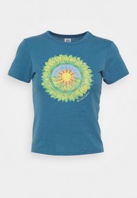 Teal cotton t-shirt with short sleeves features a circular sun design in yellow and orange, surrounded by green leaves and blue accents.