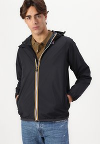 Black windbreaker jacket with a hood, featuring a front zipper with yellow, blue, and white stripes, and two side pockets.