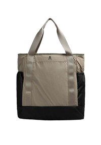 Bolso tote en beige y negro, con un gran compartimento principal, dos asas de transporte y un pequeño logo de calavera en la parte frontal.