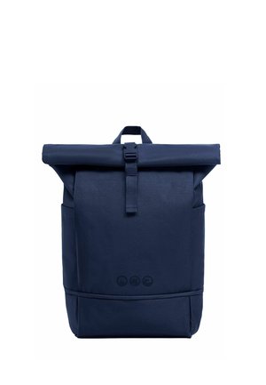 Navy blue roll-top backpack with front buckle strap, two side pockets, and three small circular logos near the bottom center.