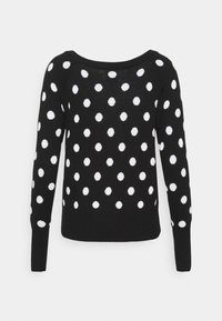 Schwarzer Pullover mit langen Ärmeln und weitem Ausschnitt, verziert mit weißen Punkten in verschiedenen Größen, aus einem weichen, strukturierten Strickmaterial.