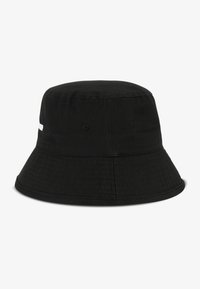 Black cotton bucket hat with a wide brim, textured surface, and discrete branding detail on the side. Classic, unadorned design.