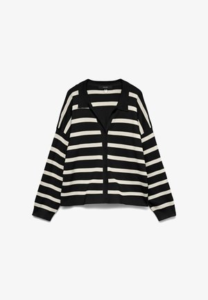 Mustra mustriga mustardi, millel on krae, pikad varrukad ja eesnuppude sulgus. Kanga näib olevat pehme ja kerge.