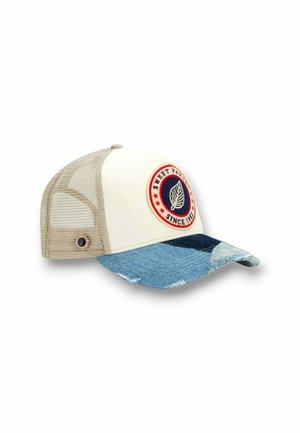 Casquette trucker en mesh beige avec panneau avant blanc, visière incurvée en denim bleu, et patch rond affichant une feuille et le texte « Sweet Pants Since 1982 ».