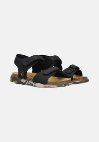 Black sandals with adjustable straps, cork footbed, and a translucent multi-colored rubber sole featuring a textured finish.