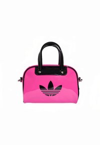 Geantă de mână din piele lacuită roz, cu accente negre, formă rotunjită, două mânere și un logo Adidas negru proeminent pe partea din față.