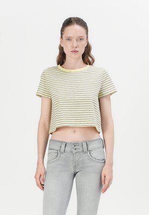 Cropped yellow and white striped t-shirt with a round neckline, paired with light gray skinny jeans featuring a button fly and subtle pockets.