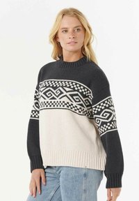 Maglione lavorato a maglia con scollo rotondo, parte superiore nera con motivo geometrico, corpo crema e bordo e polsini a coste.