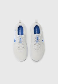 White athletic shoes with mesh upper, blue accents, and Nike logo. Features a cushioned sole and lace fastenings for secure fit.