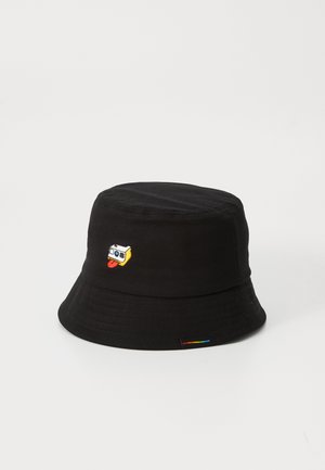 Black bucket hat made of cotton featuring an embroidered cartoon character with a yellow and white face and a red tongue on the front.
