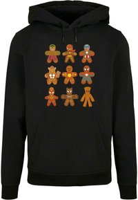 Felpa nera con cappuccio decorata con figure di pan di zenzero colorate in stile cartone animato che somigliano a supereroi, disposte in tre righe sulla parte anteriore.