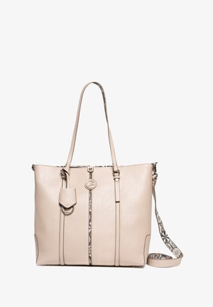 Beige leather tote bag with dual handles and a detachable strap. Features a decorative pattern strip and a logo medallion on the front.