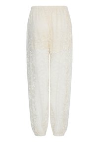 Pantalon blanc en dentelle pour femmes avec ceinture élastique et bas froncés, présentant un motif floral sur tout le tissu.