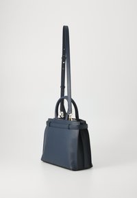 Navy leather handbag featuring dual top handles, adjustable shoulder strap, and gold-tone hardware. Rectangular shape with textured finish.