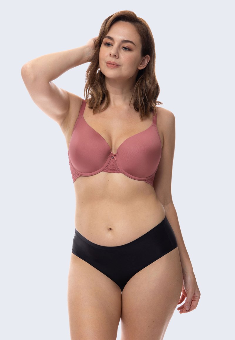 Wireless bra in soft rose color with lace accents, smooth cups, and adjustable straps; paired with black seamless hipster underwear.