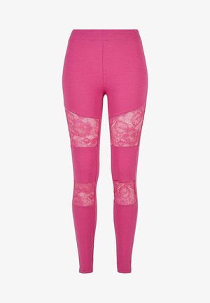 Rosa Leggings mit transparenten Spitzenpaneelen an den Seiten. Der Stoff ist glatt und dehnbar mit einer enganliegenden Passform. Ideal für legere Anlässe.