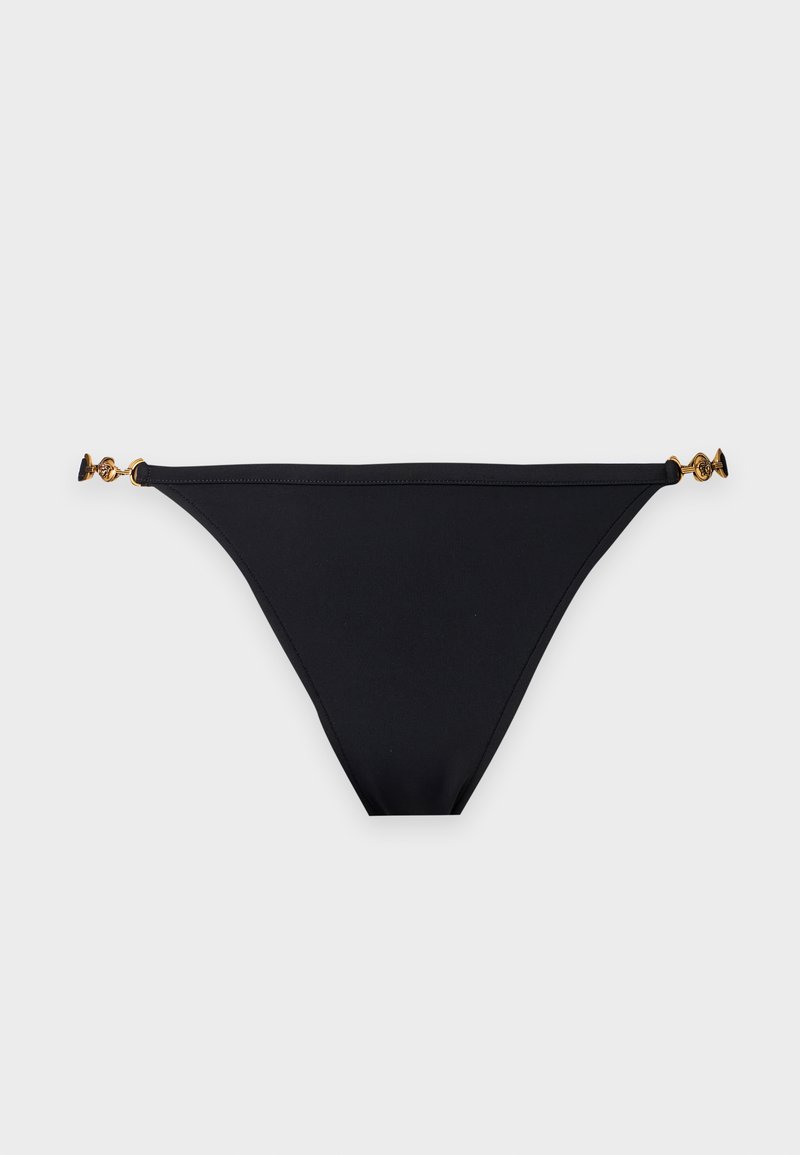 Bas de bikini noir avec fines bretelles latérales ornées de petites boucles décoratives dorées sur fond gris clair.