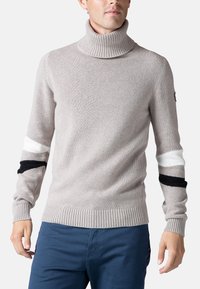 Maglione a collo alto grigio chiaro con colletto e polsini a coste. Presenta strisce bianche e nere a contrasto sulle maniche, realizzato in tessuto lavorato a maglia.