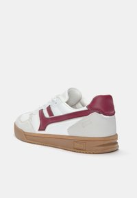 White sneaker with maroon accents, textured leather and suede details, rubber sole, and brand logo on the heel. Rear view highlights design.