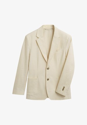 Blazer beige chiaro realizzato con tessuto testurizzato. Presenta un rever a punta, due tasche frontali, tre bottoni e dettagli di cucitura sottili.