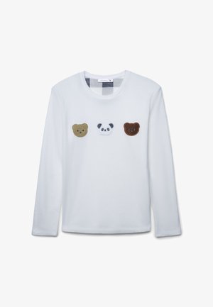 Camicia bianca a maniche lunghe con tre facce di animali in feltro applicate: un orso color sabbia, un panda e un orso marrone scuro. Collo arrotondato e texture morbida.