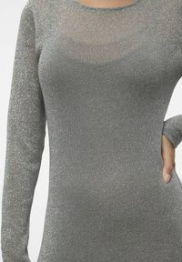 Mörkgrå långärmad klänning i metallisk trikå, med rund halsringning och en åtsittande siluett med en jämn textur och subtil lyster.