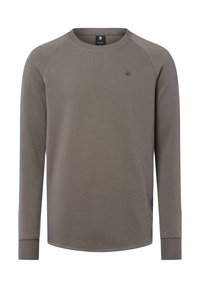 Graues Langarmshirt mit einer strukturierten Waffeloptik, geripptem Rundhalsausschnitt und figurnahen Bündchen. Verfügt über ein kleines Logo auf der Brust.