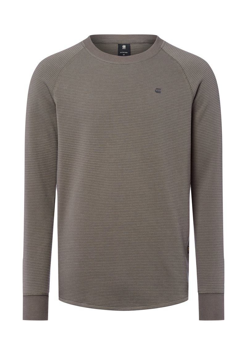Graues Langarmshirt mit einer strukturierten Waffeloptik, geripptem Rundhalsausschnitt und figurnahen Bündchen. Verfügt über ein kleines Logo auf der Brust.