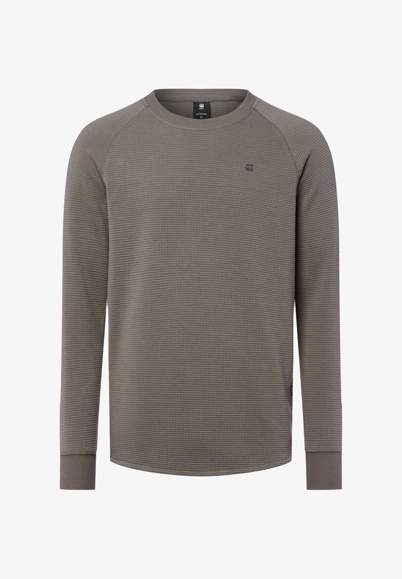 Graues Langarmshirt mit einer strukturierten Waffeloptik, geripptem Rundhalsausschnitt und figurnahen Bündchen. Verfügt über ein kleines Logo auf der Brust.