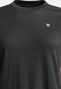 Black short-sleeved T-shirt in a smooth, textured fabric with a crew neckline, featuring a small white logo on the chest and subtle pink accents.