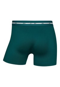 Teal boxer briefs made of stretch fabric with a contrasting white waistband featuring "JBS" logo. Smooth texture and fitted shape.