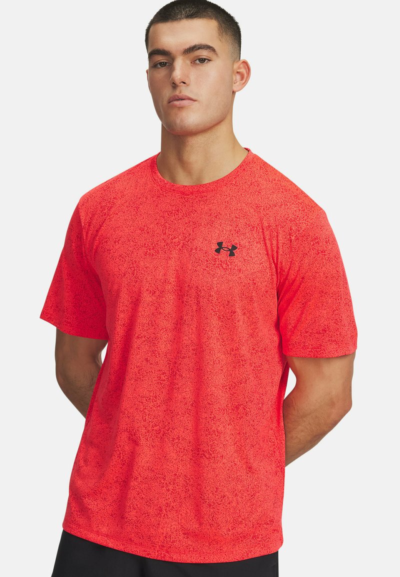 Červené atletické tričko s krátkym rukávom s textúrovaným vzorom, s malým čiernym logom Under Armour na ľavej hrudi.