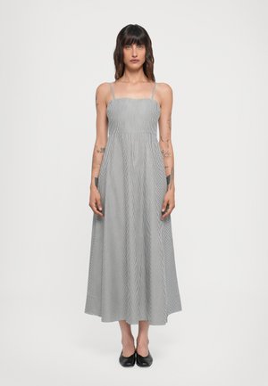 Striped, sleeveless maxi dress in gray and white. Features a fitted bodice with a flowing skirt. Lightweight fabric and adjustable straps.