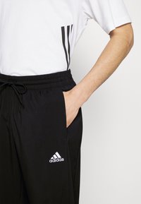 adidas Sportswear ESSENTIALS - Spodnie treningowe