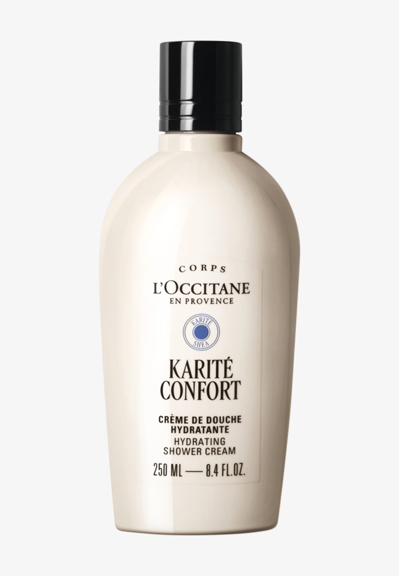 Kremowy żel pod prysznic nawilżający L'Occitane Karité Confort, 250 ml, biały pojemnik z czarną nakrętką i etykietą z tekstem w języku francuskim i angielskim.