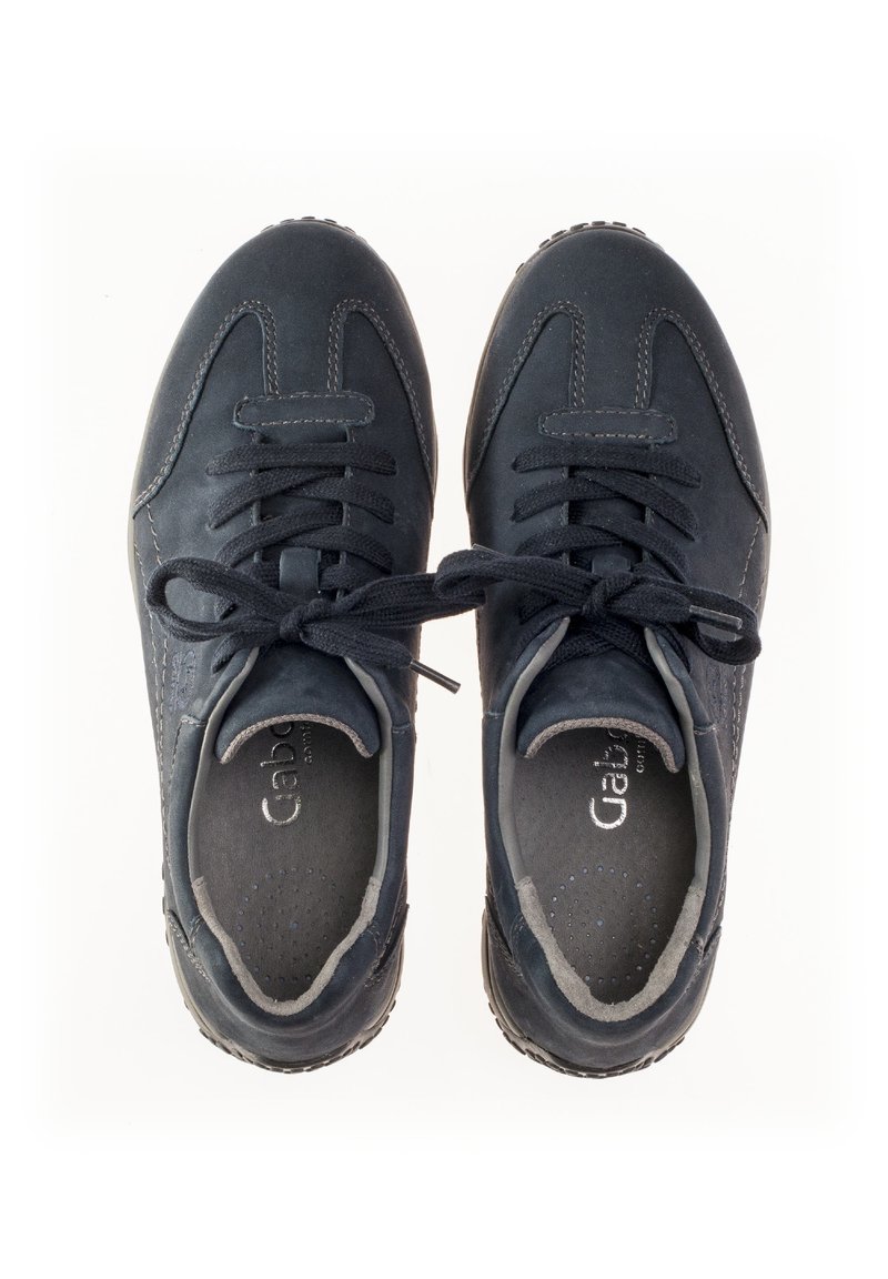 Navy blue sneakers made of suede, featuring a lace-up design, padded tongue, and perforated accents on the sides for breathability.