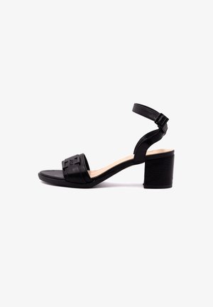 Black heeled sandal with a wide strap across the toes, ankle strap with buckle, and a block heel. Material appears smooth and textured.